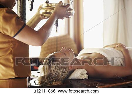 Stock Photograph - Woman getting aromatherapy in spa. Fotosearch