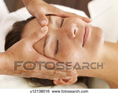 Stock Photograph - Woman getting facial massage in spa. Fotosearch