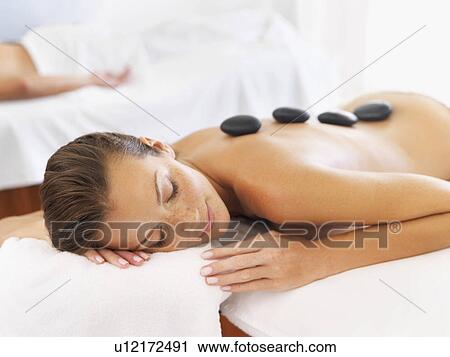 Woman getting hot stone therapy in spa View Large Photo Image Stock Image - Woman getting hot stone therapy in spa. Fotosearch