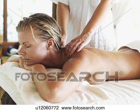Stock Image - Woman getting massage in spa. Fotosearch