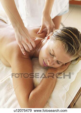 Stock Photo - Woman getting massage in spa. Fotosearch