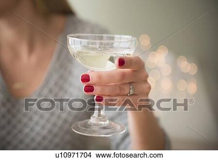 Picture - Woman holding champagne . Fotosearch