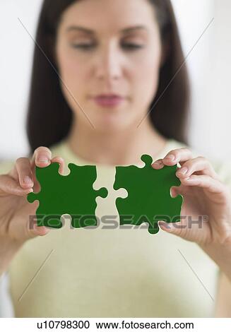 Woman holding green puzzle pieces View Large Photo Image Stock Image - Woman holding green puzzle pieces. Fotosearch