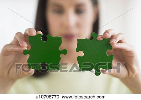 Woman holding green puzzle pieces View Large Photo Image Stock Image - Woman holding green puzzle pieces. Fotosearch