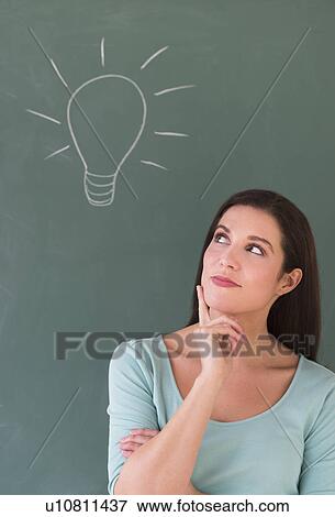 Woman in front of blackboard View Large Photo Image Stock Photo - Woman in front of blackboard. Fotosearch