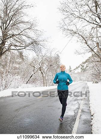 Picture - Woman jogging in winter . Fotosearch