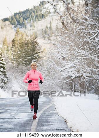 Stock Photo - Woman jogging in winter. Fotosearch