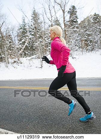 Woman jogging in winter View Large Photo Image Stock Photo - Woman jogging in winter. Fotosearch
