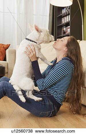 Stock Photo - Woman kissing her dog. Fotosearch