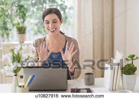 Stock Photograph - Woman online chatting. Fotosearch