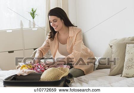 woman packing suitcase