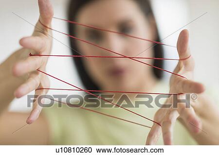 Woman playing cat's cradle View Large Photo Image Stock Image - Woman playing cat's cradle. Fotosearch