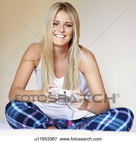 Woman playing video game View Large Photo Image Stock Photo - Woman playing video game. Fotosearch
