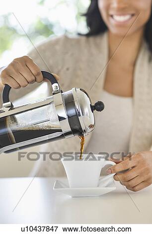 Stock Photo - Woman pouring coffee. Fotosearch