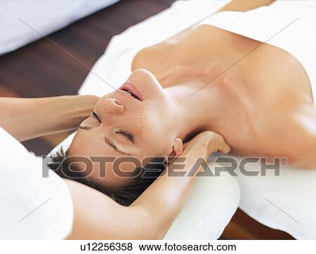 Stock Photo - Woman receiving massage in spa. Fotosearch