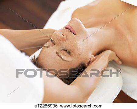 Stock Photograph - Woman receiving massage in spa. Fotosearch