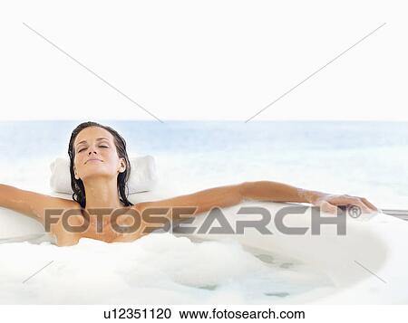Stock Image - Woman relaxing in bathtub. Fotosearch