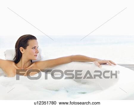Stock Image - Woman relaxing in bathtub. Fotosearch