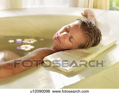 Stock Photo - Woman relaxing in bathtub. Fotosearch