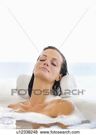 Stock Photo - Woman relaxing in bathtub. Fotosearch