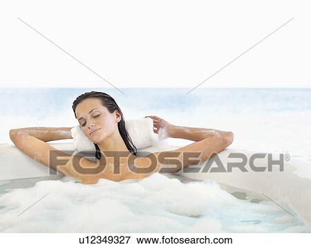 Woman relaxing in bathtub View Large Photo Image Stock Photo - Woman relaxing in bathtub. Fotosearch