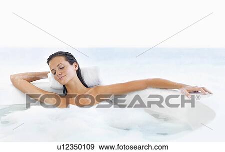 Woman relaxing in bathtub View Large Photo Image Stock Photo - Woman relaxing in bathtub. Fotosearch