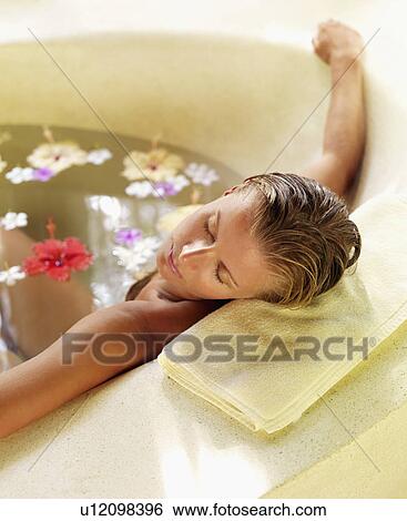 Woman relaxing in bathtub View Large Photo Image Stock Photograph - Woman relaxing in bathtub. Fotosearch
