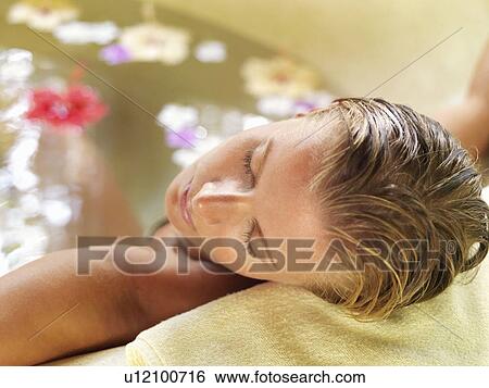 Woman relaxing in bathtub View Large Photo Image Stock Photograph - Woman relaxing in bathtub. Fotosearch