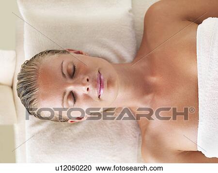 Stock Image - Woman relaxing in spa. Fotosearch