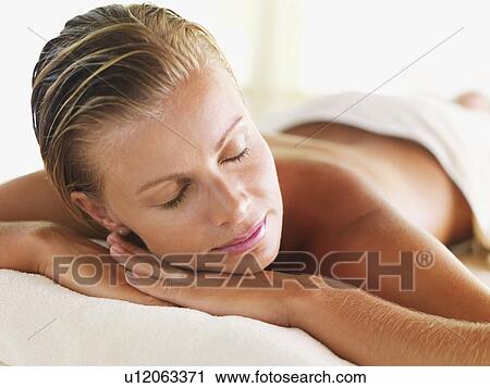 Stock Image - Woman relaxing in spa. Fotosearch