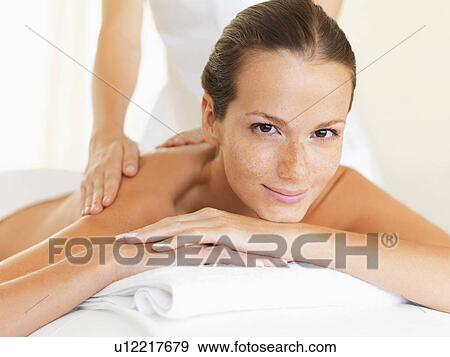 Woman relaxing while getting massage View Large Photo Image Stock Photo - Woman relaxing while getting massage. Fotosearch
