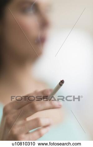 Stock Image - Woman smoking cigarette. Fotosearch