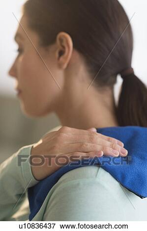 Stock Photo - Woman touching aching back. Fotosearch