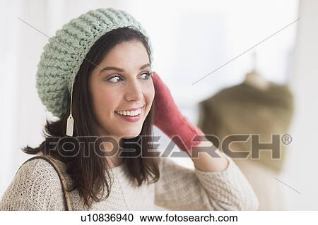 Woman trying on knit hat View Large Photo Image Stock Image - Woman trying on knit hat. Fotosearch