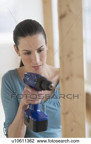Woman using hand drill View Large Photo Image Stock Image - Woman using hand drill. Fotosearch