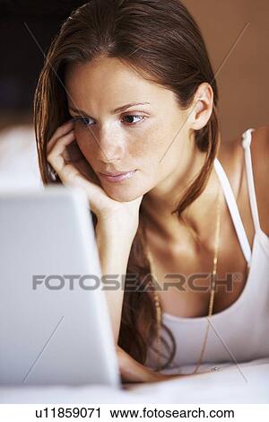 Stock Image - Woman using laptop. Fotosearch