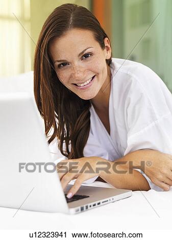Stock Image - Woman using laptop. Fotosearch