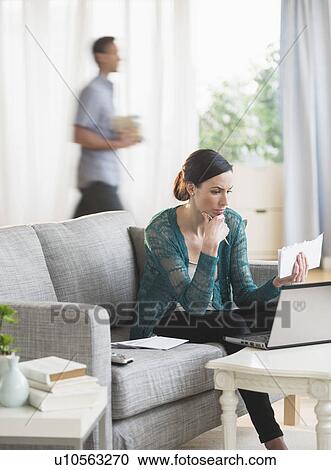 Woman using laptop to pay bills View Large Photo Image Stock Image - Woman using laptop to pay bills. Fotosearch