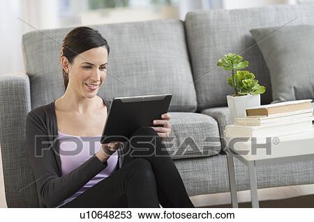 Stock Image - Woman using tablet pc. Fotosearch