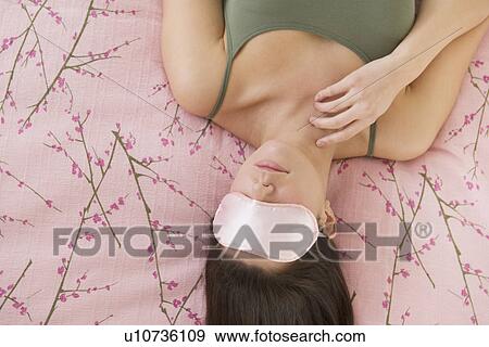 Woman with sleep mask lying on bed View Large Photo Image Stock Photo - Woman with sleep mask lying on bed . Fotosearch