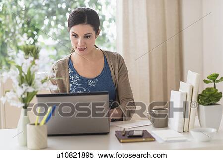 Woman working on laptop View Large Photo Image Stock Photography - Woman working on laptop. Fotosearch