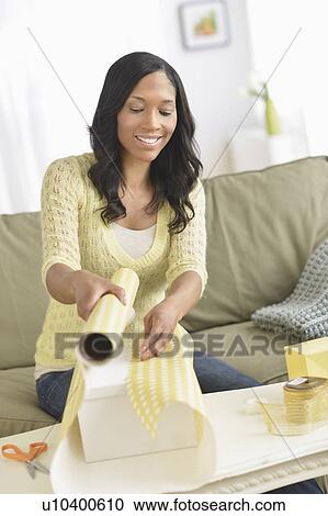 Woman wrapping presents View Large Photo Image Stock Image - Woman wrapping presents. Fotosearch