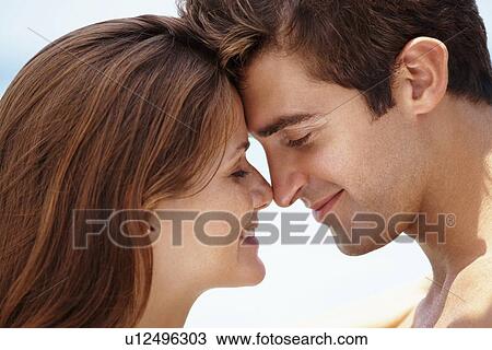 Stock Image - Young attractive couple enjoying summer holiday on beach. Fotosearch