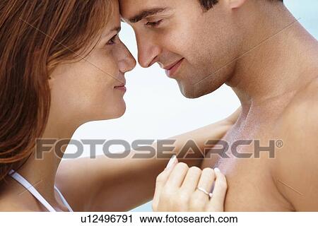 Stock Image - Young attractive couple enjoying summer holiday on beach. Fotosearch