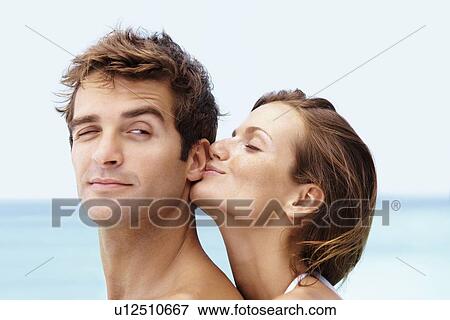 Young attractive couple enjoying summer holiday on beach View Large Photo Image Stock Photo - Young attractive couple enjoying summer holiday on beach. Fotosearch
