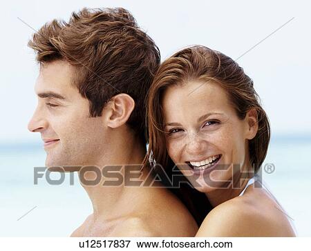 Young attractive couple enjoying summer holiday on beach View Large Photo Image Stock Photo - Young attractive couple enjoying summer holiday on beach. Fotosearch