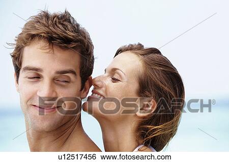 Young attractive couple enjoying summer holiday on beach View Large Photo Image Stock Photograph - Young attractive couple enjoying summer holiday on beach. Fotosearch