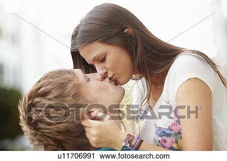 Stock Image - Young couple kissing. Fotosearch