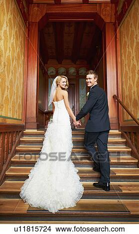 Young couple standing on steps in hallway View Large Photo Image Picture - Young couple standing on steps in hallway. Fotosearch