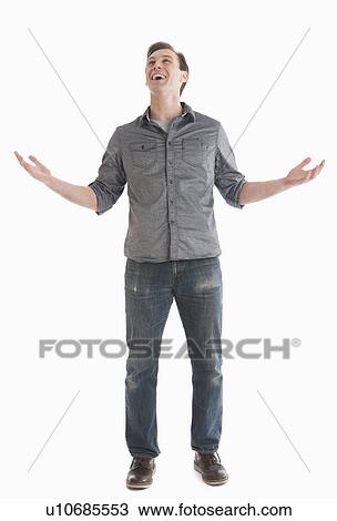 Stock Image - Young man looking up and gesturing. Fotosearch